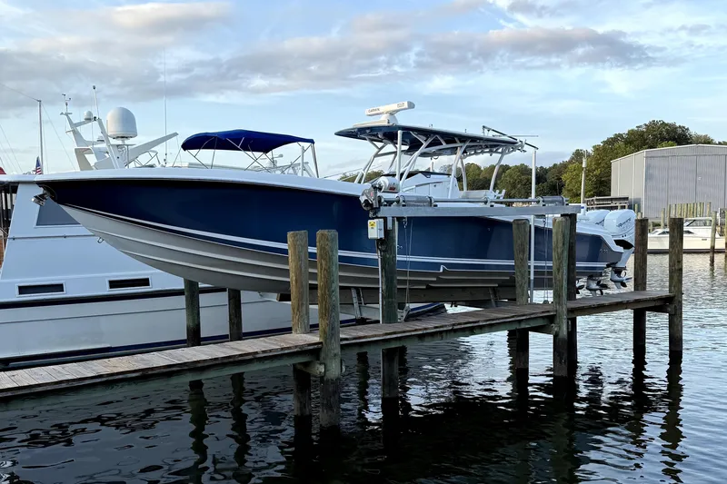 Slide: The Image of 2017 Nor-Tech 392 Superfish boat docked at marina, blue hull, calm water. - 5