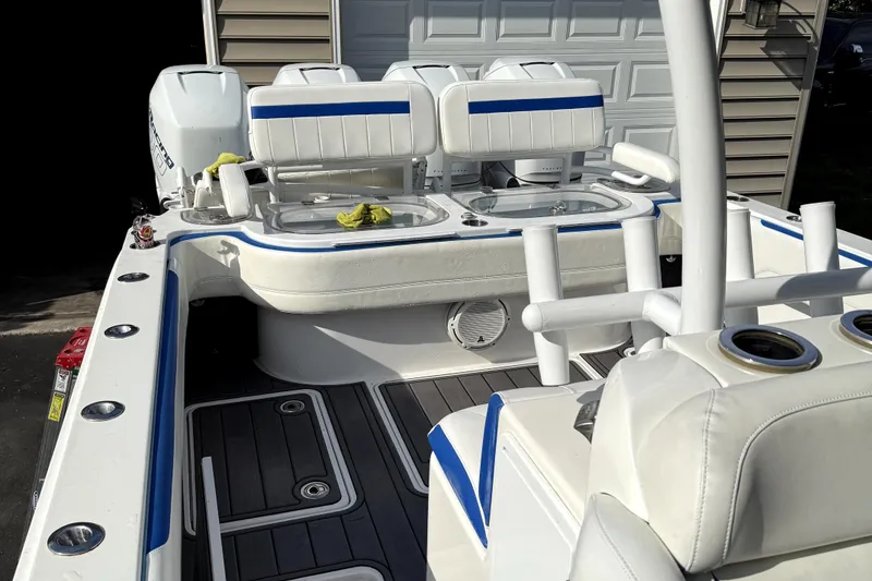 Slide: The Image of 2017 Nor-Tech 392 Superfish boat interior with white and blue seating, fishing rod holders, and storage. - 9