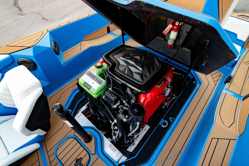 Slide: The Image of 2026 Nautique Ski Nautique boat engine compartment with vibrant blue and tan interior. - 2