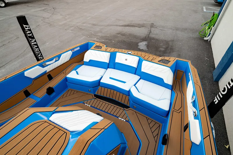 Slide: The Image of 2026 Nautique Ski Nautique boat interior with blue and white seating, wooden accents. - 3