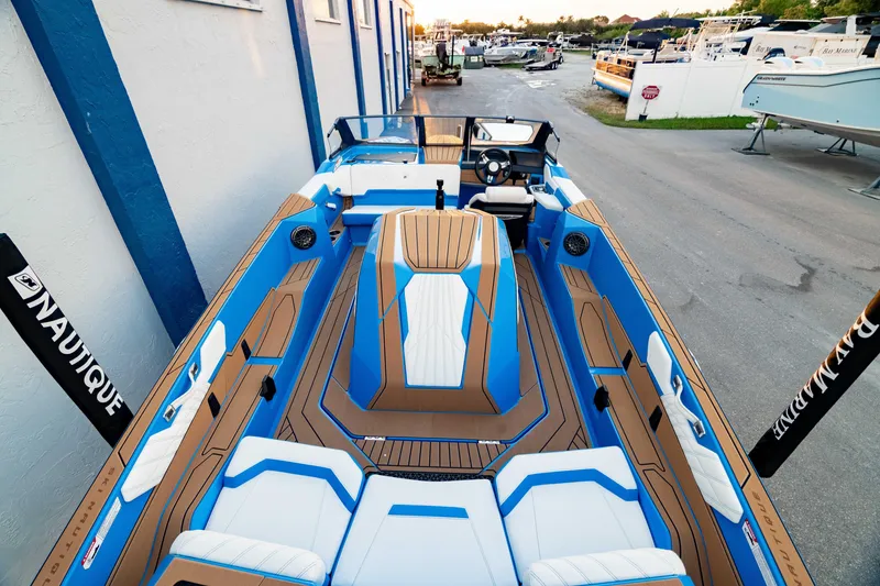 Slide: The Image of 2026 Nautique Ski Nautique boat with sleek blue and white interior design. - 8