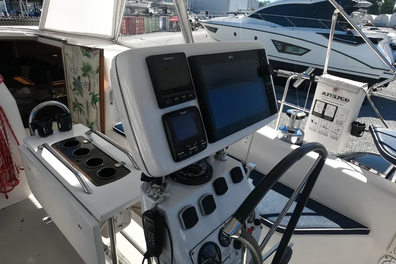 Slide: The Image of Cockpit of 2005 Catalina Morgan 440 sailboat with navigation equipment and steering wheel. - 11