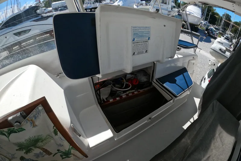 Slide: The Image of 2005 Catalina Morgan 440 yacht interior with open storage compartment and visible equipment. - 13