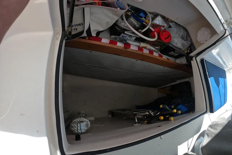Slide: The Image of Storage compartment of a 2005 Catalina Morgan 440 sailboat, filled with boating equipment. - 14