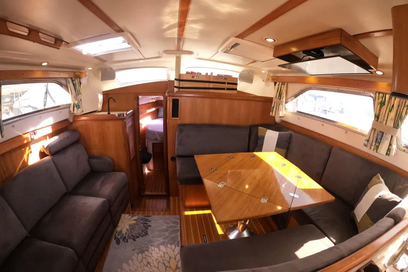 Slide: The Image of Luxurious 2005 Catalina Morgan 440 yacht interior with cozy seating and elegant wood finishes. - 23