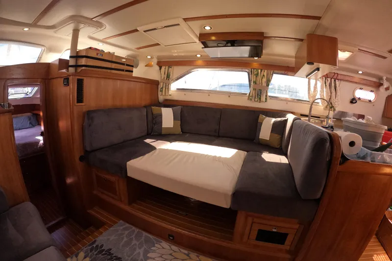 Slide: The Image of Luxurious interior of 2005 Catalina Morgan 440 yacht with cozy seating and elegant wood finish. - 25