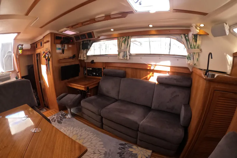 Slide: The Image of Interior of 2005 Catalina Morgan 440 yacht with cozy seating and wooden accents. - 26