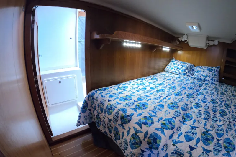Slide: The Image of Cozy cabin interior of 2005 Catalina Morgan 440 yacht with blue patterned bedding. - 35