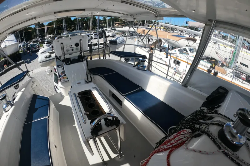 Slide: The Image of 2005 Catalina Morgan 440 yacht interior with blue seating and control panel. - 6