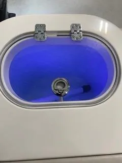 Slide: The Image of Sailfish 245DC 2022 livewell with blue interior lighting. - 10