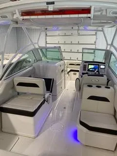 Slide: The Image of 2022 Sailfish 245DC boat interior with modern seating and navigation system. - 11