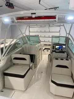 Slide: The Image of 2022 Sailfish 245DC boat interior with modern seating and navigation system. - 12