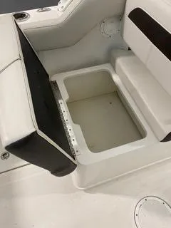 Slide: The Image of 2022 Sailfish 245DC boat seat with storage compartment, white and black upholstery. - 14