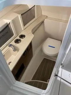 Slide: The Image of 2022 Sailfish 245DC boat interior with sink and toilet. - 16