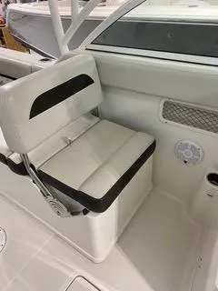 Slide: The Image of 2022 Sailfish 245DC boat interior seat with black and white upholstery. - 17