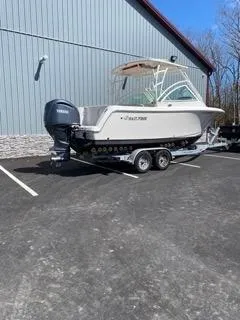 Slide: The Image of 2022 Sailfish 245DC boat on trailer in parking lot. - 2
