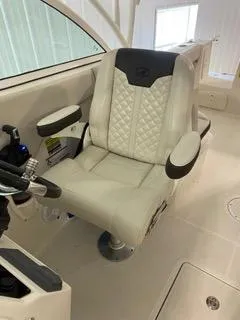 Slide: The Image of 2022 Sailfish 245DC boat captain's chair with quilted upholstery and armrests. - 21