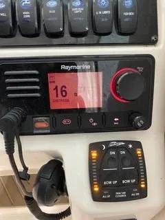 Slide: The Image of Control panel of 2022 Sailfish 245DC boat with Raymarine display and switches. - 24