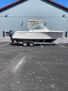 Slide: The Image of 2022 Sailfish 245DC boat on trailer, parked outside a building. - 3