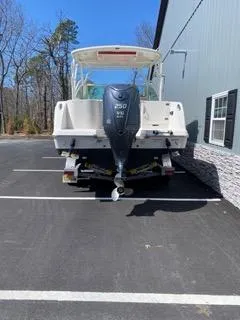 Slide: The Image of 2022 Sailfish 245DC boat with outboard motor in parking lot. - 6