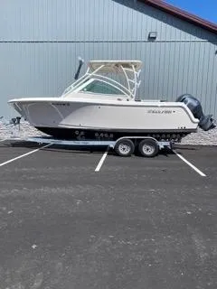 Slide: The Image of 2022 Sailfish 245DC boat on trailer, parked outdoors. - 7