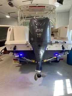 Slide: The Image of 2022 Sailfish 245DC boat with Yamaha 250 V6 engine in a garage. - 8
