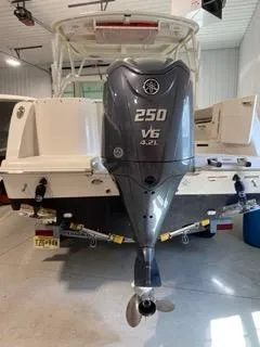 Slide: The Image of 2022 Sailfish 245DC boat with 250 V6 engine in a garage. - 9