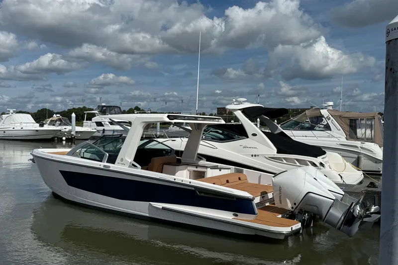 Slide: The Image of 2022 Aviara AV32 OB boat docked at marina under cloudy sky. - 1