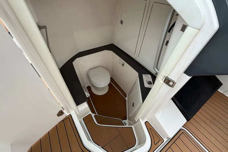 Slide: The Image of 2022 Aviara AV32 OB boat bathroom with modern design and wood flooring. - 13