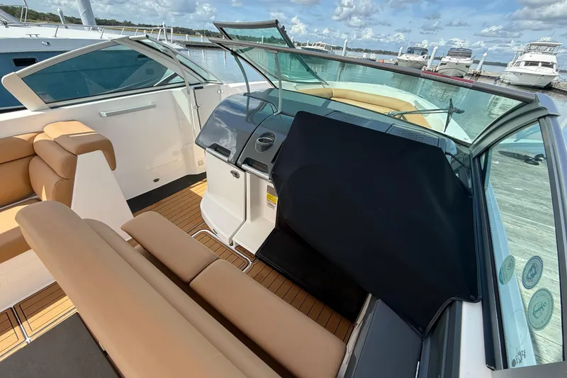 Slide: The Image of 2022 Aviara AV32 OB boat interior with tan seating and sleek dashboard design. - 15