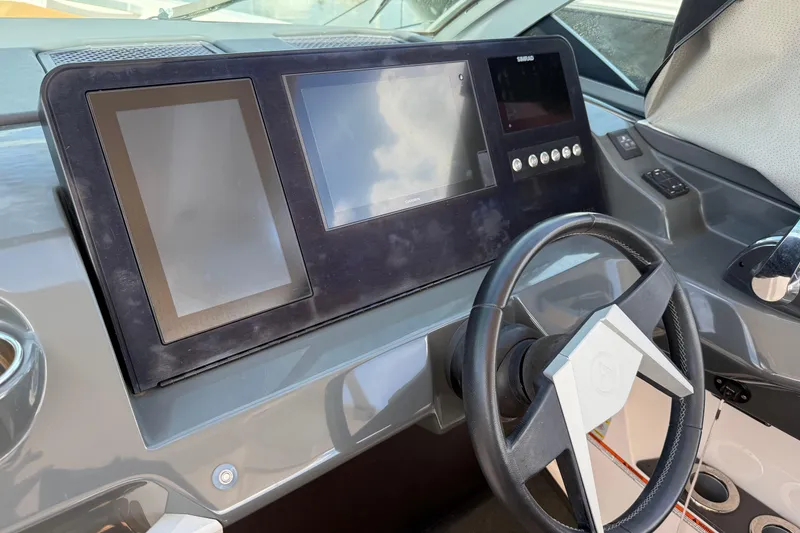 Slide: The Image of 2022 Aviara AV32 OB helm with modern touchscreen displays and steering wheel. - 16