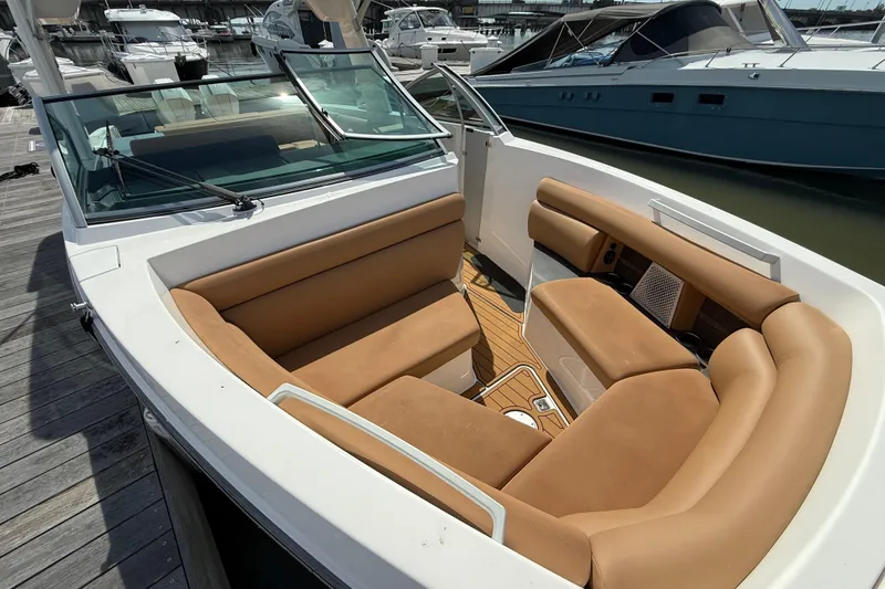 Slide: The Image of 2022 Aviara AV32 OB boat with tan seating, docked at a marina. - 18