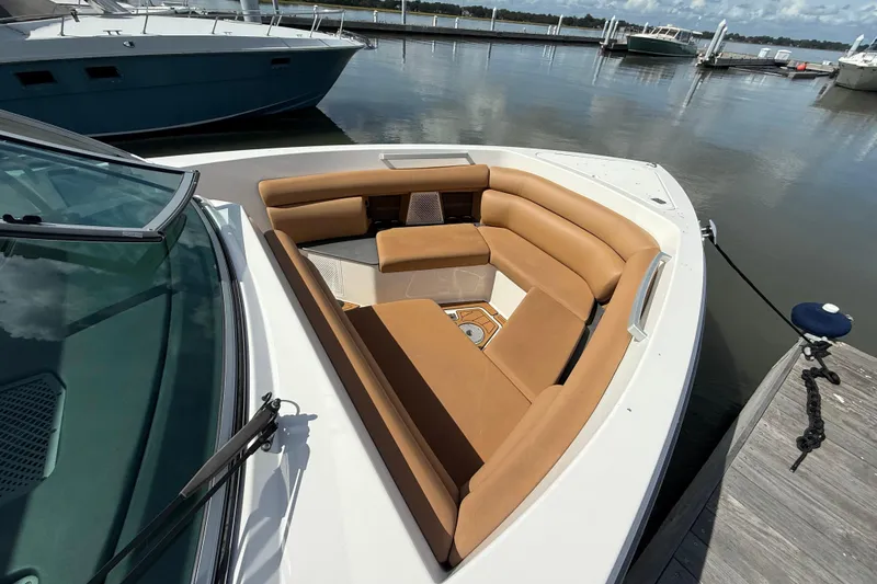 Slide: The Image of 2022 Aviara AV32 OB boat with tan seating, docked at a marina. - 19