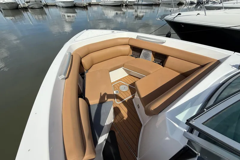 Slide: The Image of 2022 Aviara AV32 OB boat with tan seating and wooden deck, docked at marina. - 20