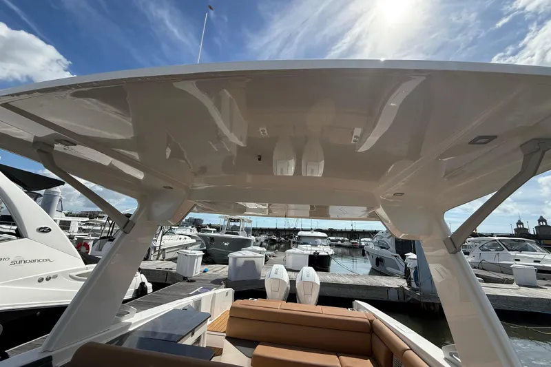 Slide: The Image of 2022 Aviara AV32 OB boat at marina, showcasing sleek design and spacious seating. - 21