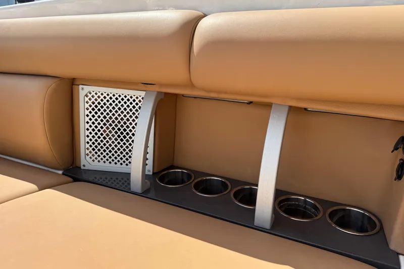 Slide: The Image of 2022 Aviara AV32 OB boat interior with tan seating and built-in cup holders. - 23