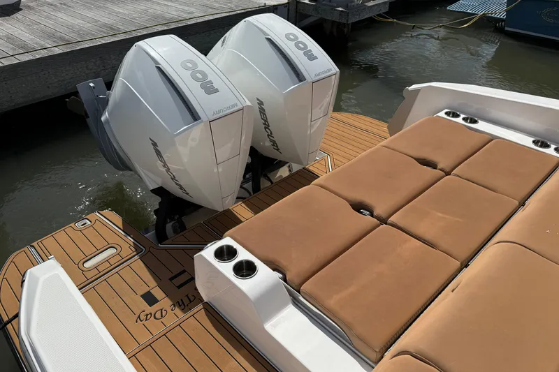 Slide: The Image of 2022 Aviara AV32 OB boat with twin Mercury outboard engines and cushioned deck seating. - 5
