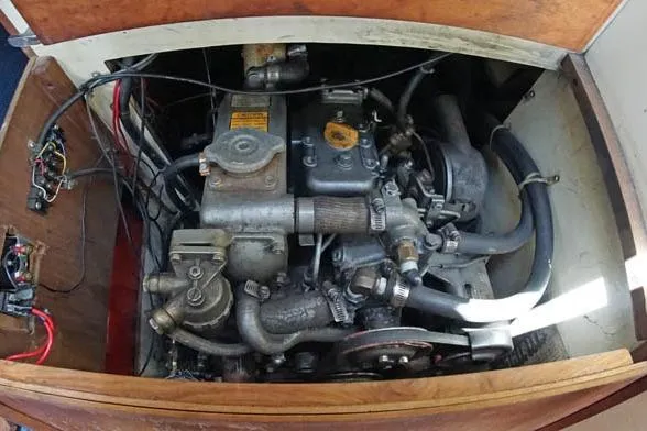 Slide: The Image of Engine compartment of a 1983 Pearson 303 sailboat, showcasing mechanical components and wiring. - 4