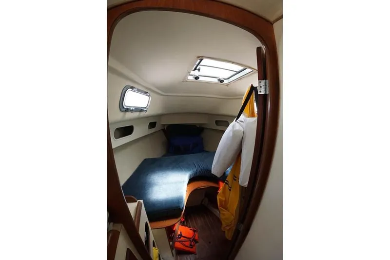 Slide: The Image of Cozy cabin interior of 1983 Pearson 303 sailboat with bed and porthole. - 7