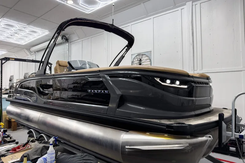 The Image of 2026 Godfrey Sanpan 25' Tritoon boat in a well-lit indoor setting. - 0