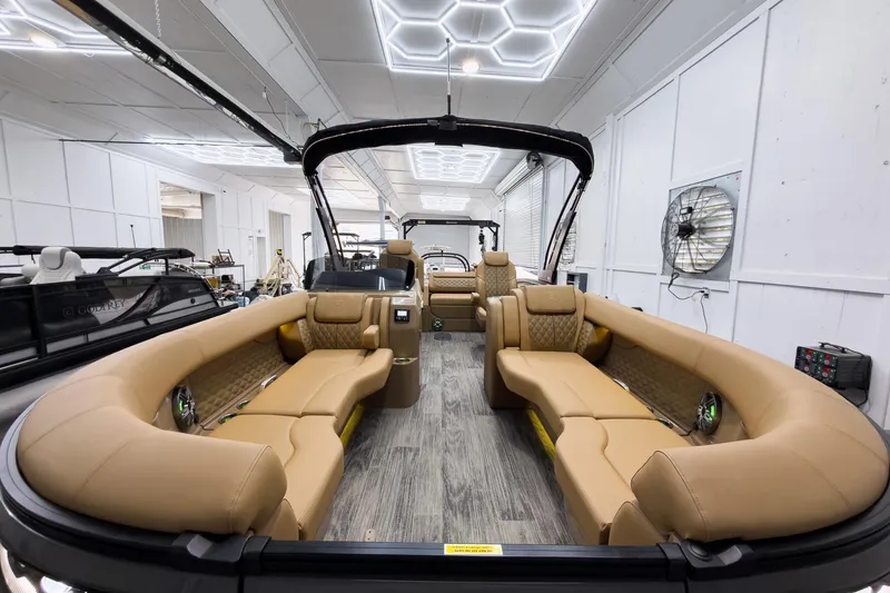 Slide: The Image of Luxurious interior of 2026 Godfrey Sanpan 25' Tritoon with tan seating and modern design. - 12