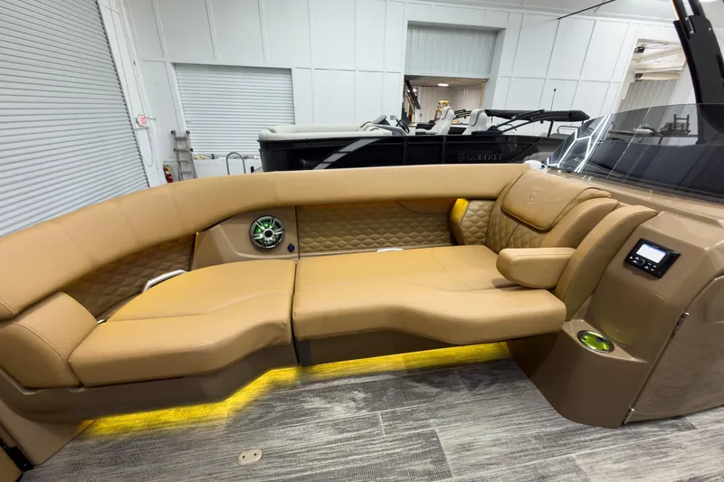 Slide: The Image of Luxurious interior of 2026 Godfrey Sanpan 25' Tritoon with tan seating and modern amenities. - 19