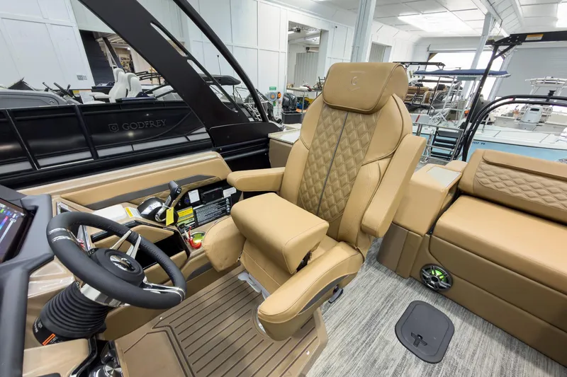 Slide: The Image of Luxurious interior of 2026 Godfrey Sanpan 25' Tritoon with plush seating and modern controls. - 23