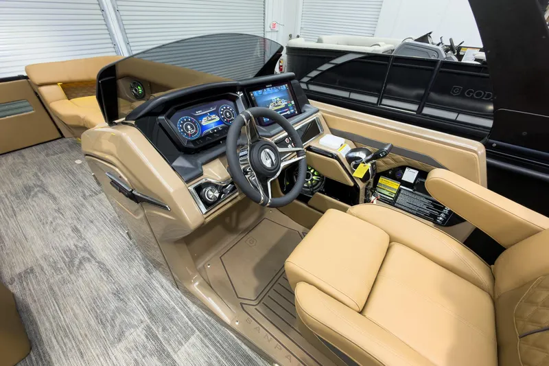 Slide: The Image of Luxurious 2026 Godfrey Sanpan 25' Tritoon interior with advanced dashboard and plush seating. - 24