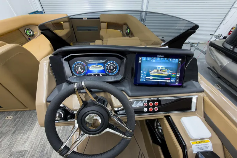 Slide: The Image of 2026 Godfrey Sanpan 25' Tritoon dashboard with advanced controls and touchscreen display. - 25