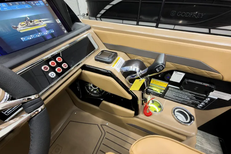 Slide: The Image of Interior of 2026 Godfrey Sanpan 25' Tritoon, featuring modern controls and luxurious design. - 28