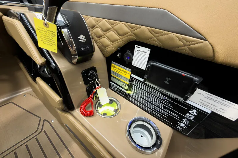 Slide: The Image of Control panel of 2026 Godfrey Sanpan 25' Tritoon with safety warnings and cup holder. - 29