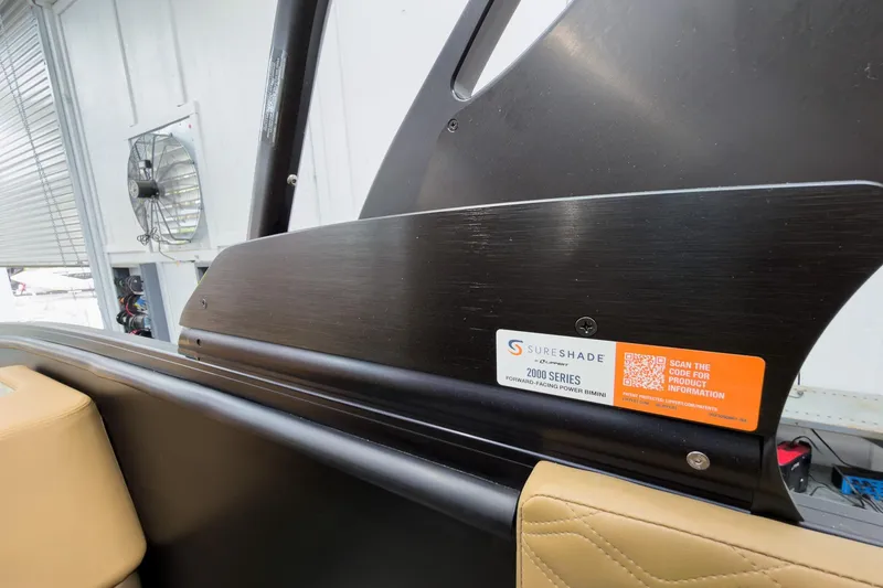 Slide: The Image of 2026 Godfrey Sanpan 25' Tritoon with SureShade 2000 Series Bimini in a showroom. - 34