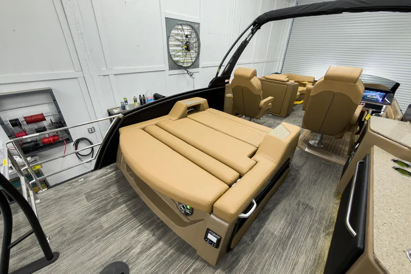 Slide: The Image of 2026 Godfrey Sanpan 25' Tritoon interior with luxurious tan seating and modern amenities. - 38