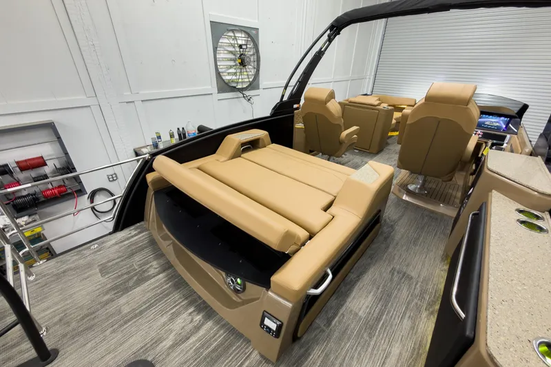 Slide: The Image of Luxurious 2026 Godfrey Sanpan 25' Tritoon with tan flip lounge seating in a modern interior. - 41